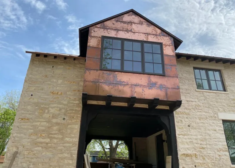 Copper metal panel facade on a stone building for Skylight Installation in Sebring